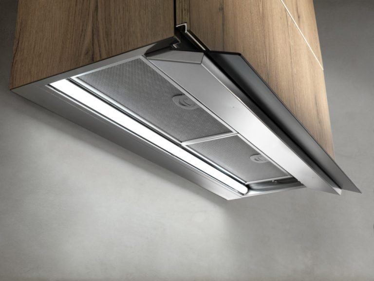 A sleek modern kitchen featuring a stylish stainless steel hood above a contemporary stove, showcasing a clean design.