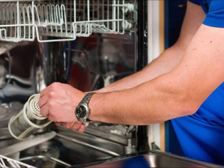 A man is cleaning the interior of a dishwasher using another dishwasher, showcasing a unique cleaning method.