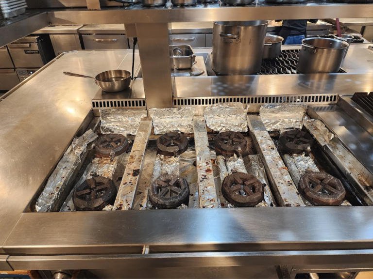 A vibrant kitchen featuring a conveyor belt filled with various delicious dishes ready to be served.